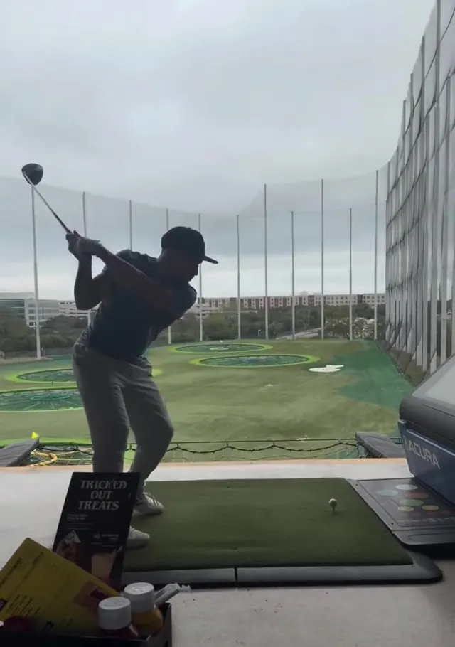 Eric hitting a drive at the range